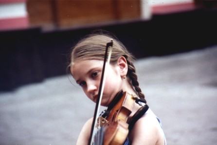 Little girl playing violin on old Arbat street